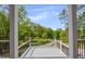 Covered porch framed by white columns, black railings, and a beautiful green landscape view at 2841 Bettis Ct, Marietta, GA 30066