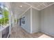 Long covered porch featuring wood-look tile flooring, white columns, and a gray board and batten wall at 2841 Bettis Ct, Marietta, GA 30066