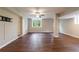 View of a finished basement with a ceiling fan, a window, and wood-look flooring at 3803 Butternut Dr, Decatur, GA 30034