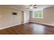 Finished basement area with wood-look flooring, a window, and a ceiling fan at 3803 Butternut Dr, Decatur, GA 30034