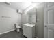 Neutral bathroom featuring a modern vanity, toilet, and mirrored medicine cabinet for storage at 3803 Butternut Dr, Decatur, GA 30034