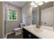 Bright bathroom with modern fixtures, a tiled shower, and natural light from the window at 3803 Butternut Dr, Decatur, GA 30034