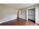 Bedroom featuring wood floors, a closet with organizers, and neutral wall paint at 3803 Butternut Dr, Decatur, GA 30034