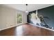 Dining room with hardwood floors, statement wallpaper art, and modern lighting fixture at 3803 Butternut Dr, Decatur, GA 30034