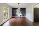 Dining room with hardwood floors, statement wallpaper art, and pendant lighting fixture at 3803 Butternut Dr, Decatur, GA 30034