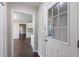The entryway reveals wood floors and a glimpse of the kitchen with white cabinetry at 3803 Butternut Dr, Decatur, GA 30034