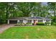Charming single-story home with a lush green lawn and inviting curb appeal at 3803 Butternut Dr, Decatur, GA 30034
