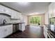 Charming kitchen featuring updated cabinets and granite countertops with a large window overlooking the backyard at 3803 Butternut Dr, Decatur, GA 30034