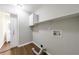 A laundry room with white cabinets, a shelf, and connections for a washer and dryer at 3803 Butternut Dr, Decatur, GA 30034