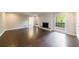 Spacious living room with hardwood floors, fireplace, and a large window for ample natural light at 3803 Butternut Dr, Decatur, GA 30034