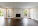 Bright living room featuring a cozy fireplace, hardwood floors, and a window with a lush view at 3803 Butternut Dr, Decatur, GA 30034