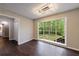 A bright living room features wood flooring and a large window showcasing an attractive backyard at 3803 Butternut Dr, Decatur, GA 30034