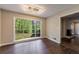 Bright living room with large window and hardwood floors, looking out to a wooded backyard at 3803 Butternut Dr, Decatur, GA 30034