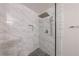 Modern shower with marble tile and a glass door in the bathroom at 3803 Butternut Dr, Decatur, GA 30034