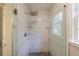 Walk-in shower featuring marble tiling, a glass door, and a rainfall shower head at 3803 Butternut Dr, Decatur, GA 30034
