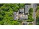 An aerial view highlights the condo community and surrounding greenery and road access at 404 Wade Creek Rd, Alpharetta, GA 30009