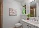 This bathroom has a shower, along with a white vanity and large mirror at 404 Wade Creek Rd, Alpharetta, GA 30009