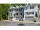 Exterior view of a row of townhomes with garage parking at 404 Wade Creek Rd, Alpharetta, GA 30009