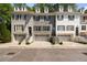 Charming townhomes with brick exteriors, dormer windows, and attached garages offer both style and convenience at 404 Wade Creek Rd, Alpharetta, GA 30009