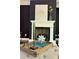 Close-up of the fireplace with white mantel and hearth, decorated with modern art and decorative accents at 404 Wade Creek Rd, Alpharetta, GA 30009