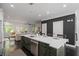 Bright open-concept kitchen features bar-stool seating, modern appliances, and connects to the dining and living spaces at 404 Wade Creek Rd, Alpharetta, GA 30009
