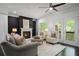 Cozy living room with a fireplace, plush seating, and natural light from windows and a door to the outside at 404 Wade Creek Rd, Alpharetta, GA 30009