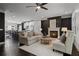 Open-concept living room featuring a fireplace, ceiling fan, and seamless flow to the kitchen and dining areas at 404 Wade Creek Rd, Alpharetta, GA 30009