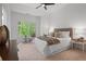 Spacious main bedroom with a large window, natural light, and tasteful decor and furniture at 404 Wade Creek Rd, Alpharetta, GA 30009