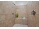 Tiled stand up shower with a built-in seat and neutral toned ceramic tiles at 404 Wade Creek Rd, Alpharetta, GA 30009
