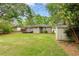 The large backyard is enhanced by mature trees and features a storage shed at 975 Shirley Se St, Smyrna, GA 30082