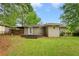 Backyard showcases a wooden deck, spacious lawn, and a charming view of the rear exterior at 975 Shirley Se St, Smyrna, GA 30082