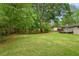 Beautiful backyard featuring a lush green lawn, mature trees, and a peaceful setting at 975 Shirley Se St, Smyrna, GA 30082