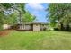 Backyard showcases a wooden deck, spacious lawn, and a charming view of the rear exterior at 975 Shirley Se St, Smyrna, GA 30082