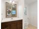 Bright bathroom with a dark wood vanity, large mirror, and natural light from the window at 975 Shirley Se St, Smyrna, GA 30082
