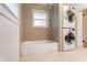 Bathroom features a tub/shower combo with a window and convenient stackable washer and dryer at 975 Shirley Se St, Smyrna, GA 30082
