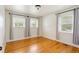Bedroom with hardwood floors, neutral walls, and two large windows with blinds at 975 Shirley Se St, Smyrna, GA 30082