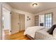 Bedroom features hardwood floors and a door to the bathroom with double doors to a laundry at 975 Shirley Se St, Smyrna, GA 30082