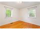 Well-lit bedroom with hardwood floors and two bright windows at 975 Shirley Se St, Smyrna, GA 30082