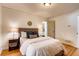 A well-lit bedroom with hardwood floors, a comfortable bed, and neutral-colored walls at 975 Shirley Se St, Smyrna, GA 30082