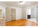 Bedroom featuring hardwood floors, closet space, and double doors that lead to the bathroom at 975 Shirley Se St, Smyrna, GA 30082