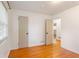 Bright bedroom with gleaming hardwood floors, large windows, and neutral paint at 975 Shirley Se St, Smyrna, GA 30082