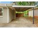 View of the carport area with concrete driveway and partial wooden fence at 975 Shirley Se St, Smyrna, GA 30082