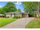Charming single-story home with a well-manicured lawn, long driveway, and light-blue front doors at 975 Shirley Se St, Smyrna, GA 30082