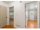 Hallway view showcasing hardwood floors and white walls, with doorways leading to other rooms at 975 Shirley Se St, Smyrna, GA 30082