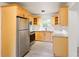 Well-lit kitchen features stainless steel appliances, granite counters, and wood cabinets at 975 Shirley Se St, Smyrna, GA 30082