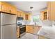 Modern kitchen features stainless steel appliances, wood cabinets, and granite countertops at 975 Shirley Se St, Smyrna, GA 30082