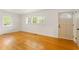 Inviting living room with hardwood floors, large windows, and a freshly painted front door at 975 Shirley Se St, Smyrna, GA 30082