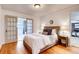 Cozy main bedroom with hardwood floors, a ceiling light, and access to the bathroom and living area at 975 Shirley Se St, Smyrna, GA 30082