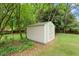 Backyard shed on a grassy lot surrounded by trees, providing extra storage at 975 Shirley Se St, Smyrna, GA 30082