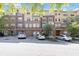 Exterior view of multi-story condo building with parking lot and landscaping at 10 Ne Perimeter Summit Ne Blvd # 4428, Brookhaven, GA 30319